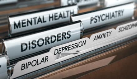 Close-up of file tabs that say "Mental Health," "Psychiatry," and "Disorders."
