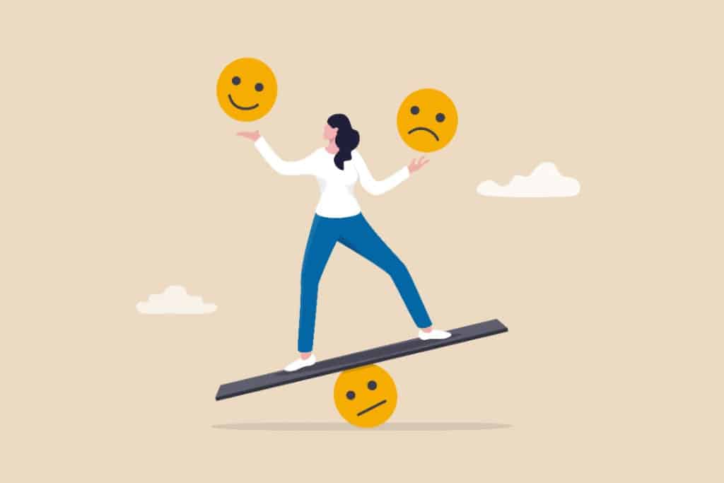 Illustration of a woman balancing on a board on a round, neutral-looking face as she compares a sad face and happy face in each hand.